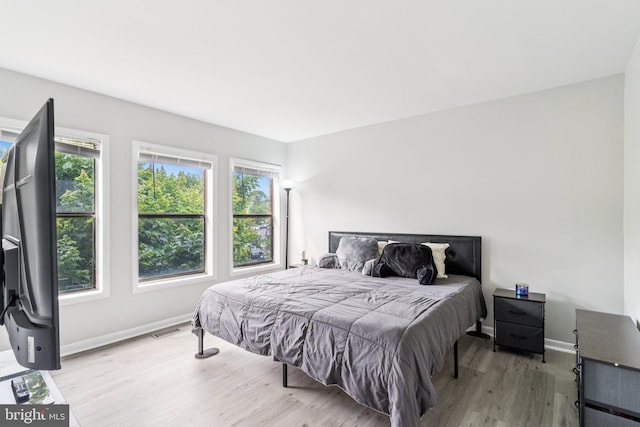 4647 6th St SE, Washington, DC 20032 - bedroom featuring wood finished floors and multiple windows