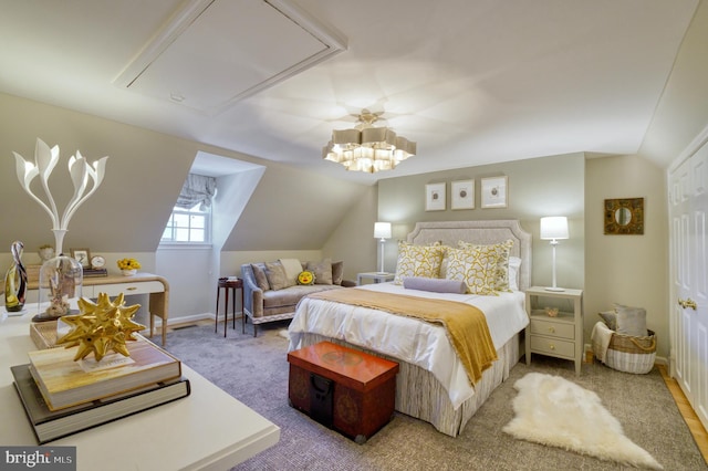 carpeted bedroom with attic access and vaulted ceiling