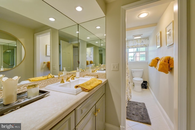 bathroom with toilet, baseboards, recessed lighting, and tile patterned floors