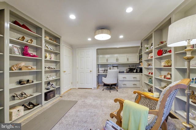 home office featuring built in study area, recessed lighting, and light carpet