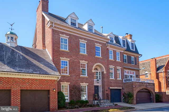 view of front of property featuring a chimney and brick siding