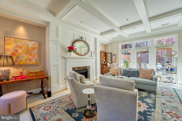 living area featuring visible vents, coffered ceiling, beam ceiling, and a premium fireplace