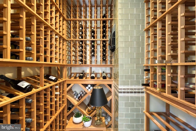 wine room with tile walls and tile patterned flooring