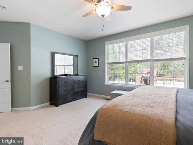 bedroom featuring a ceiling fan, baseboards, and carpet