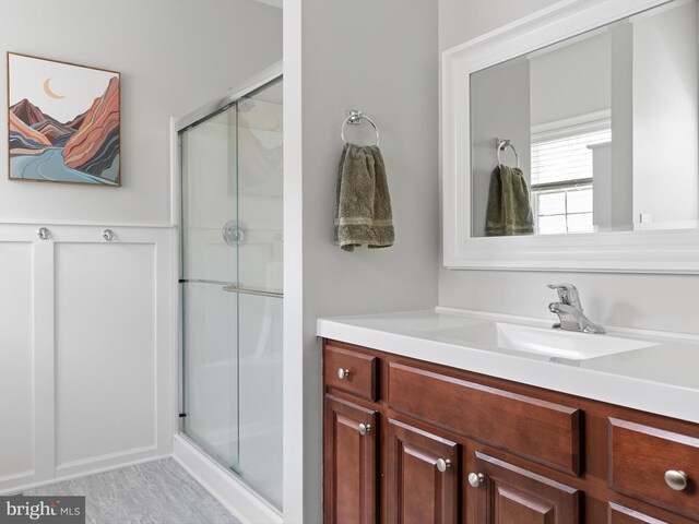 full bathroom with vanity and a stall shower