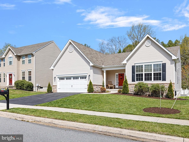 view of front of home featuring aphalt driveway, an attached garage, stone siding, roof with shingles, and a front yard