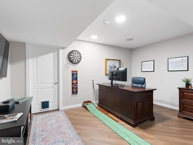 office space featuring baseboards, visible vents, light wood finished floors, and recessed lighting
