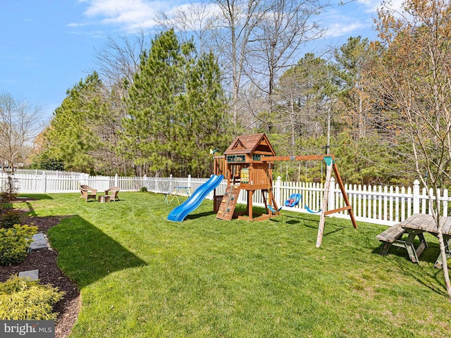 view of playground featuring fence and a yard