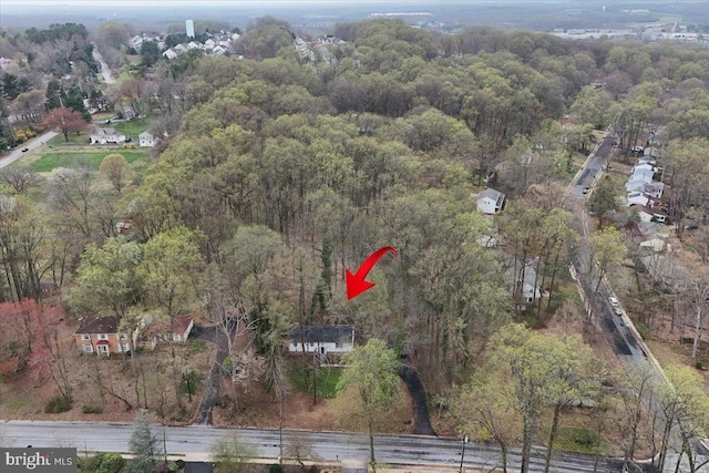 drone / aerial view featuring a view of trees