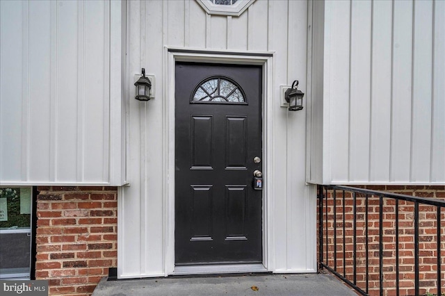 view of exterior entry with board and batten siding