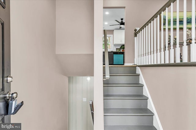 stairway featuring baseboards, ceiling fan, and recessed lighting