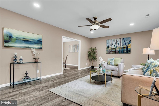 living area with a ceiling fan, wood finished floors, baseboards, visible vents, and recessed lighting
