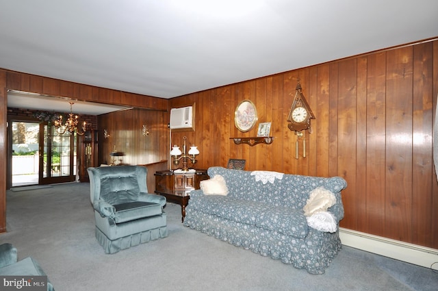 carpeted living area with wood walls, a chandelier, a wall mounted air conditioner, and a baseboard radiator