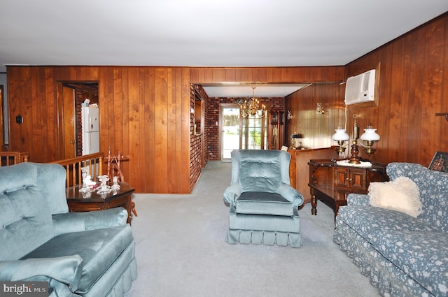 carpeted living room with an AC wall unit, wood walls, and an inviting chandelier