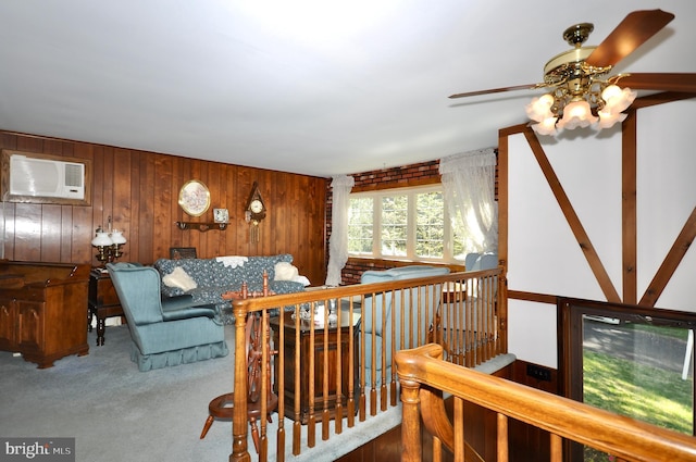 carpeted living area featuring wooden walls, an AC wall unit, and a ceiling fan