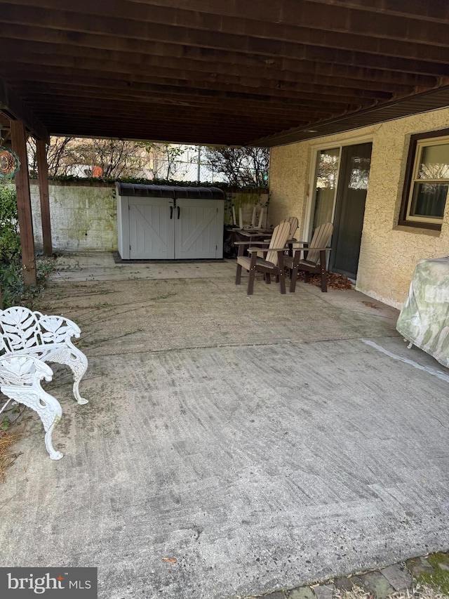 view of patio / terrace with a storage shed and an outbuilding