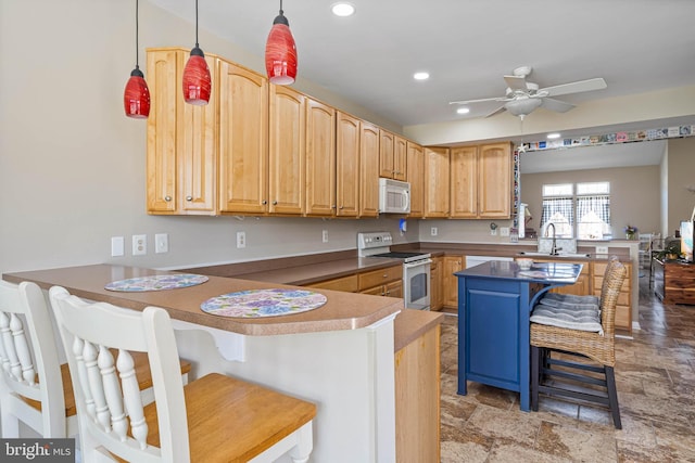 37959 Bayview Cir E, Selbyville, DE 19975 - kitchen featuring recessed lighting, white appliances, a peninsula, a ceiling fan, and a breakfast bar area