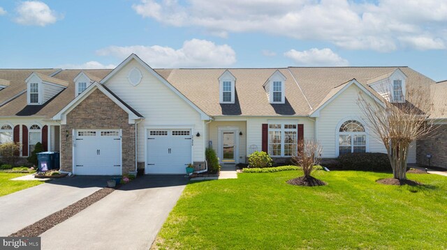 37959 Bayview Cir E, Selbyville, DE 19975 - view of front of house featuring roof with shingles, driveway, stone siding, an attached garage, and a front lawn