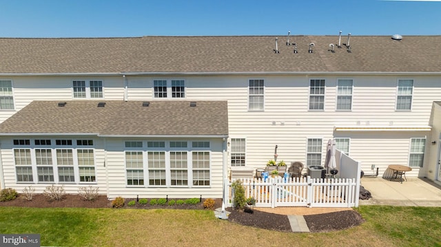 37959 Bayview Cir E, Selbyville, DE 19975 - back of house with a yard, roof with shingles, a patio area, fence, and a gate