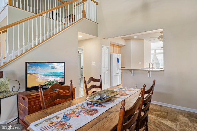 37959 Bayview Cir E, Selbyville, DE 19975 - dining space featuring stairs, a high ceiling, baseboards, and ceiling fan