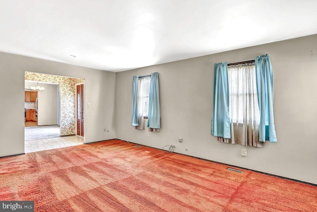 511 Chelton Ave, Burlington, NJ 08016 - empty room featuring visible vents, light colored carpet, and a notable chandelier