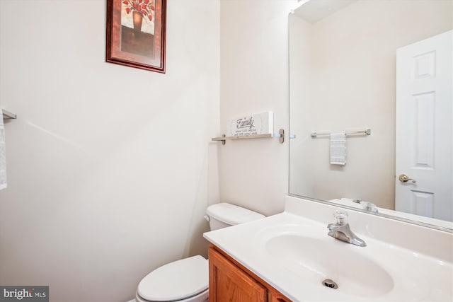 bathroom with toilet and vanity