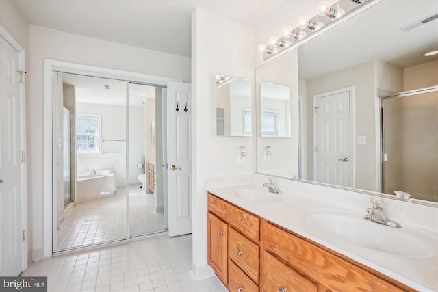 full bath with tile patterned flooring, a sink, visible vents, and double vanity