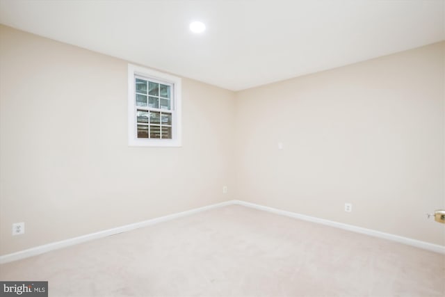 spare room featuring light colored carpet, baseboards, and recessed lighting