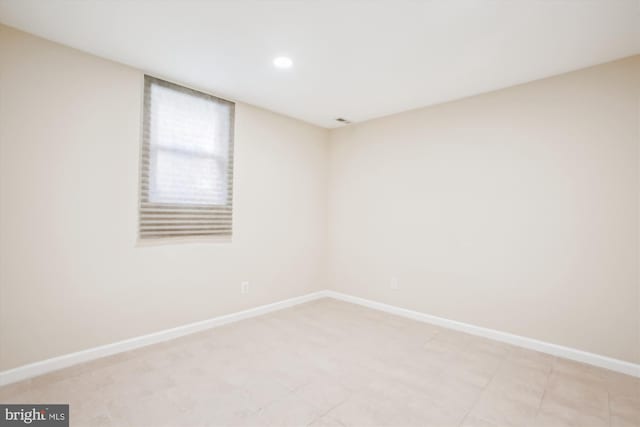 spare room with baseboards and recessed lighting