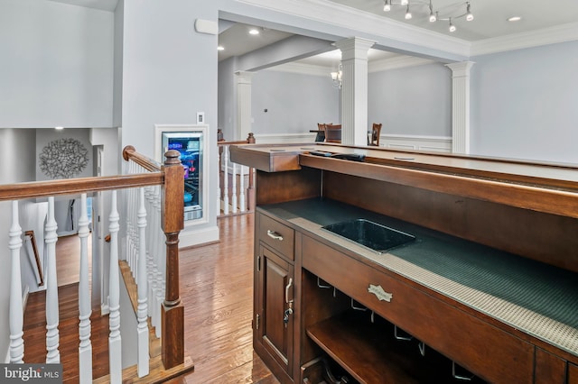 15343 Tewkesbury Pl, Upper Marlboro, MD 20774 - bar with crown molding, wood finished floors, and ornate columns
