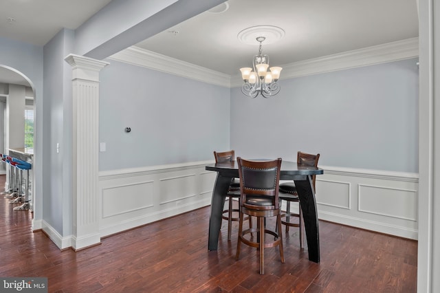 15343 Tewkesbury Pl, Upper Marlboro, MD 20774 - dining area featuring arched walkways, a chandelier, dark wood-type flooring, ornamental molding, and wainscoting