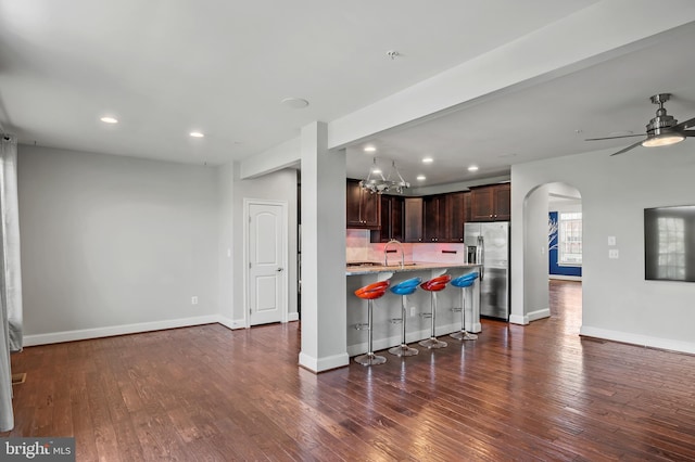 15343 Tewkesbury Pl, Upper Marlboro, MD 20774 - kitchen featuring stainless steel fridge, a breakfast bar, dark brown cabinetry, dark wood finished floors, and a sink