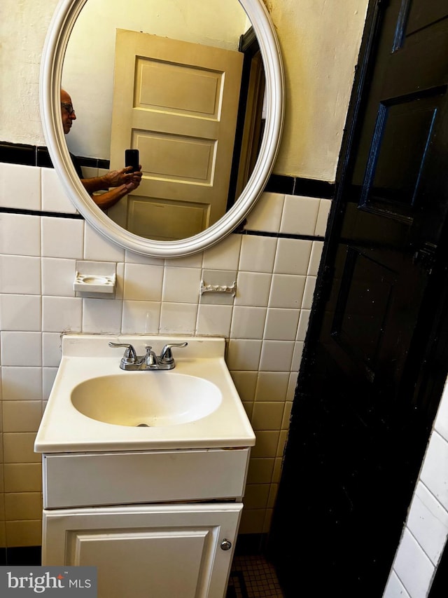 bathroom with tile walls and vanity