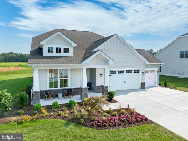 35247 Duck Haven Rd, Selbyville, DE 19975 - craftsman inspired home with driveway, stone siding, an attached garage, and covered porch