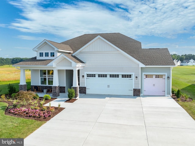 35247 Duck Haven Rd, Selbyville, DE 19975 - craftsman house featuring a porch, stone siding, a front lawn, an attached garage, and driveway