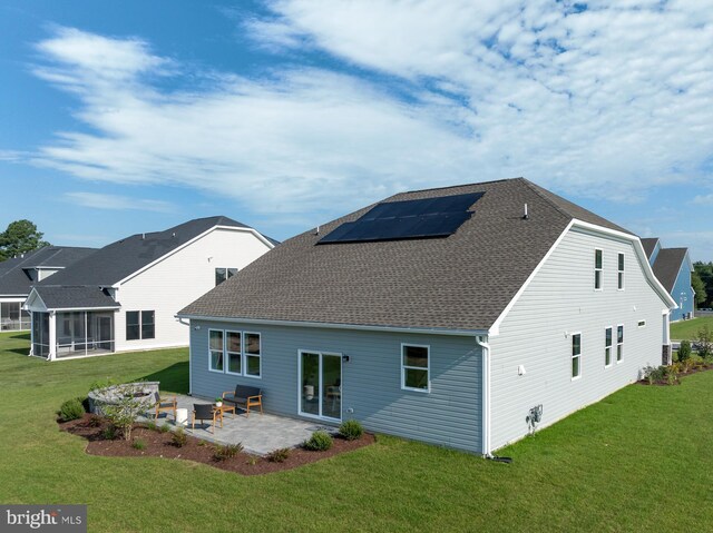 35247 Duck Haven Rd, Selbyville, DE 19975 - rear view of house featuring a yard, roof with shingles, a patio, and roof mounted solar panels