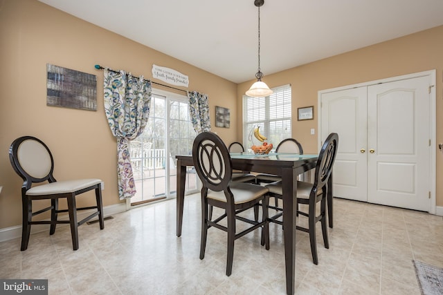 dining room featuring light tile patterned floors and baseboards