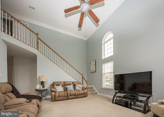 living area with high vaulted ceiling, stairway, visible vents, and carpet