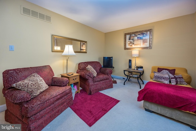 living room with baseboards, visible vents, and carpet floors