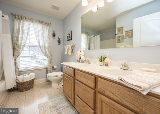 bathroom featuring a sink, visible vents, toilet, and tile patterned floors