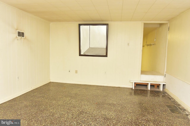 empty room featuring baseboards and visible vents