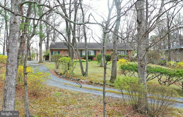 view of front of property featuring a water view and brick siding