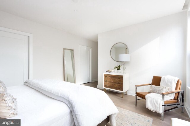 bedroom featuring wood finished floors and baseboards