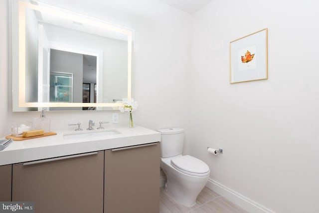 1427 Rhode Island Ave NW Unit 301, Washington, DC 20005 - bathroom with toilet, vanity, and baseboards