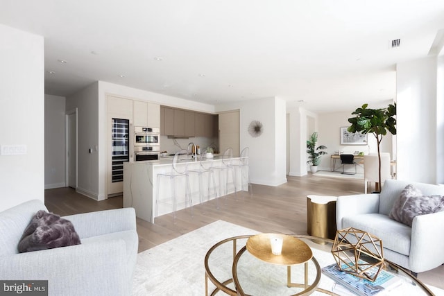 living room with light wood-style flooring and baseboards