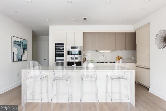 1427 Rhode Island Ave NW Unit 301, Washington, DC 20005 - kitchen featuring double oven, modern cabinets, light countertops, light wood-style flooring, and recessed lighting