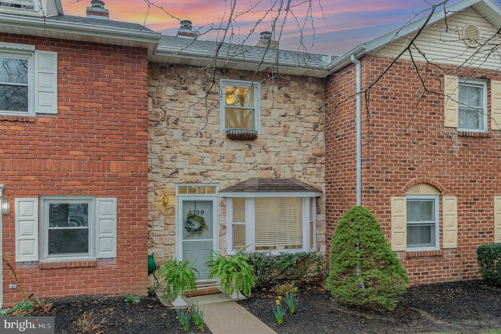 multi unit property with brick siding and stone siding