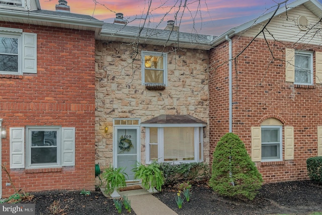 multi unit property with brick siding and stone siding