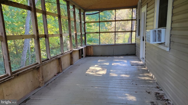 unfurnished sunroom with cooling unit and plenty of natural light