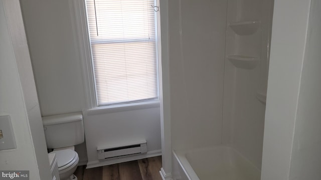 bathroom featuring baseboard heating, wood finished floors, baseboards, and toilet